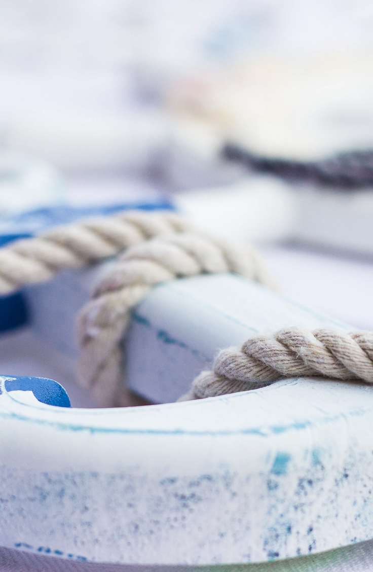 Coastal Home Decor- a blue and white anchor with rope wrapped around it.